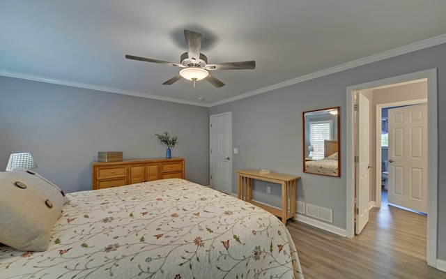 bedroom featuring crown molding, light hardwood / wood-style floors, and ceiling fan