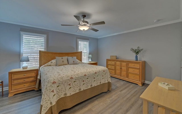 bedroom with crown molding, ceiling fan, and light wood-type flooring