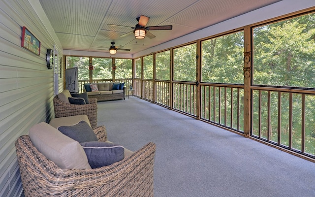 sunroom / solarium featuring ceiling fan