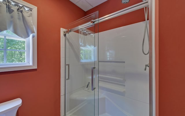 bathroom with toilet and walk in shower