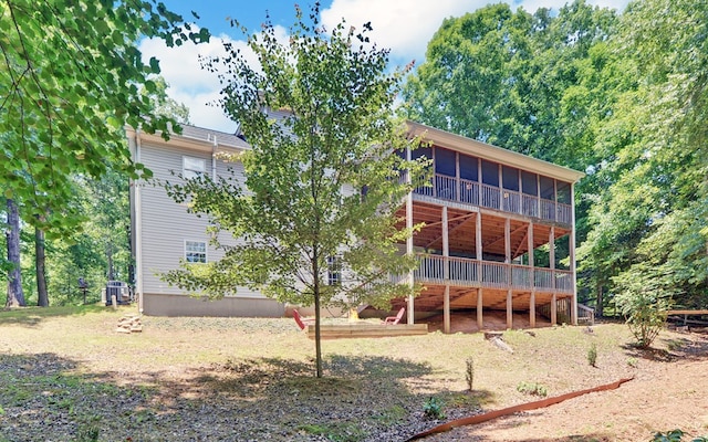 back of property with a sunroom