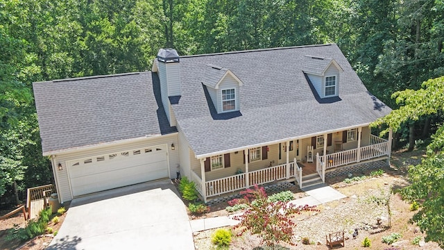 view of front of house featuring a garage and a porch