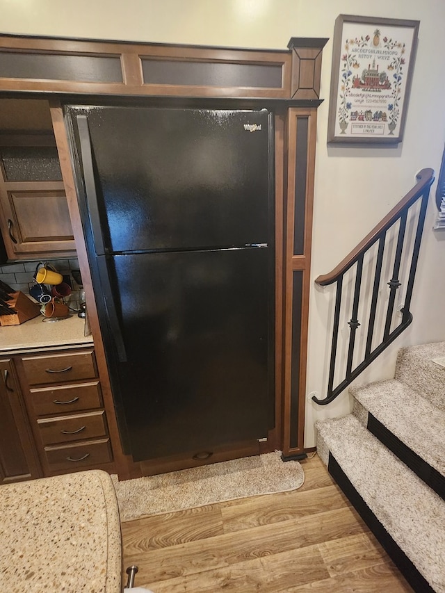 room details with wood finished floors and freestanding refrigerator