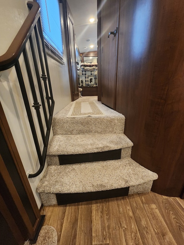 staircase with wood finished floors