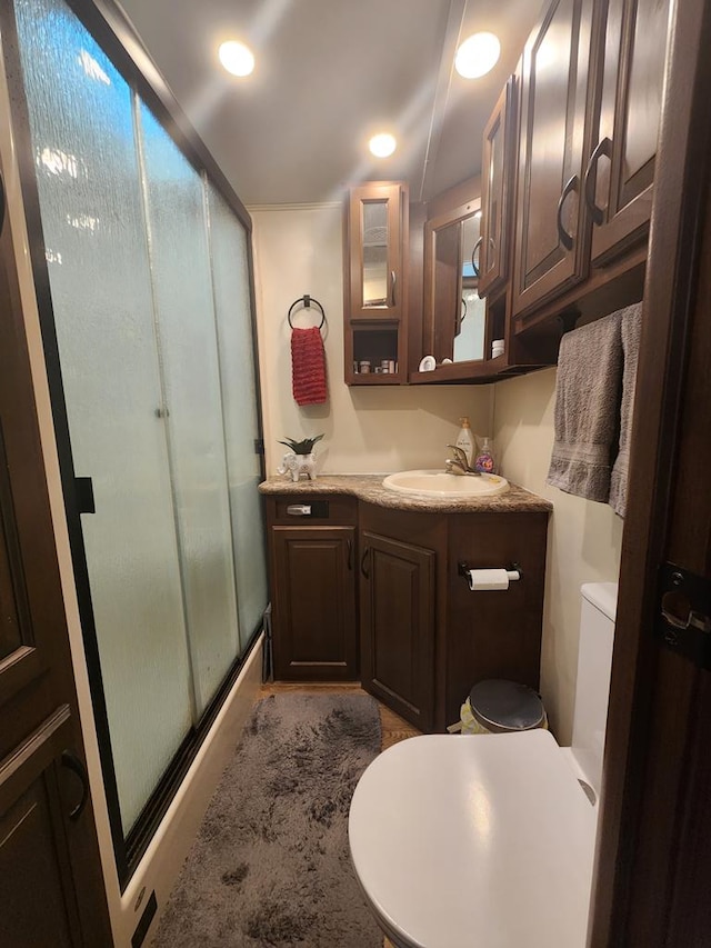 full bath with toilet, a shower stall, recessed lighting, and vanity