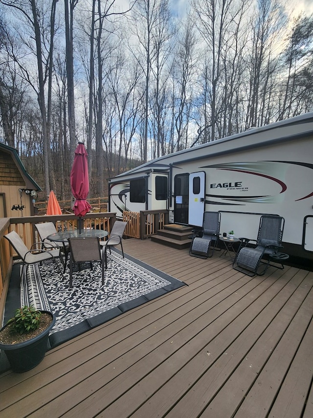 deck with outdoor dining area