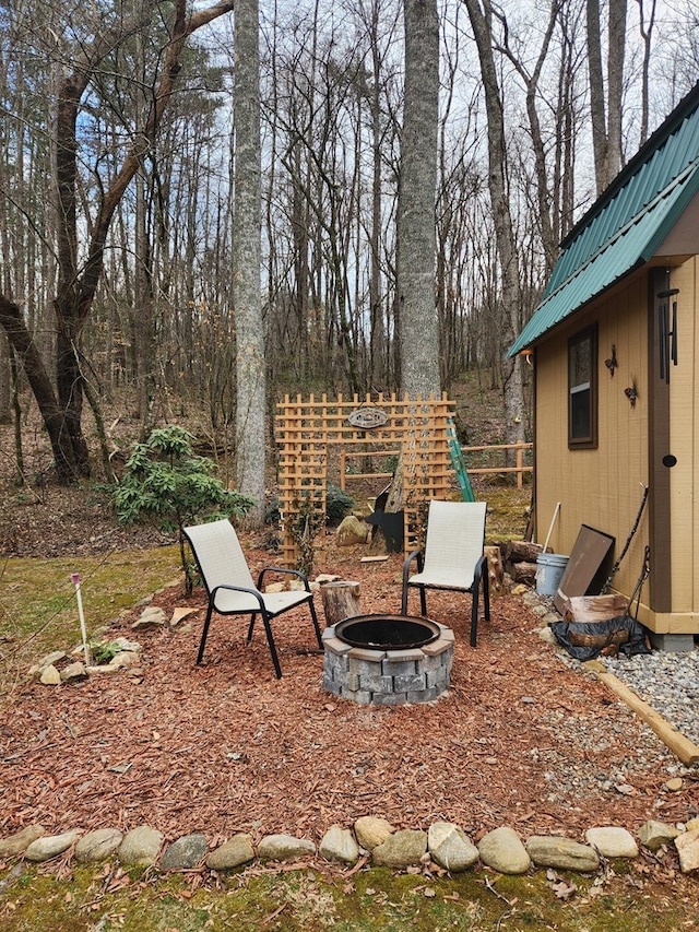 view of yard featuring a fire pit and fence