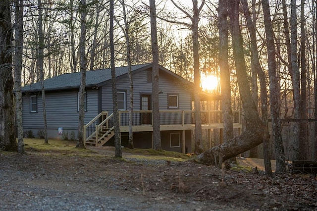 view of front of house with stairs and a deck