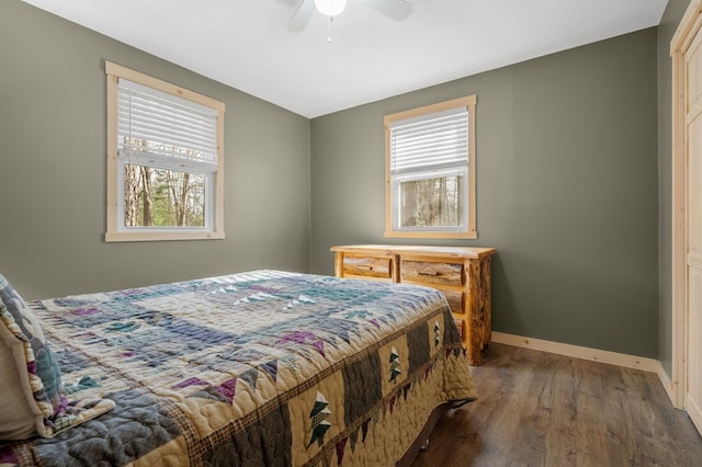 bedroom with wood finished floors, baseboards, and ceiling fan