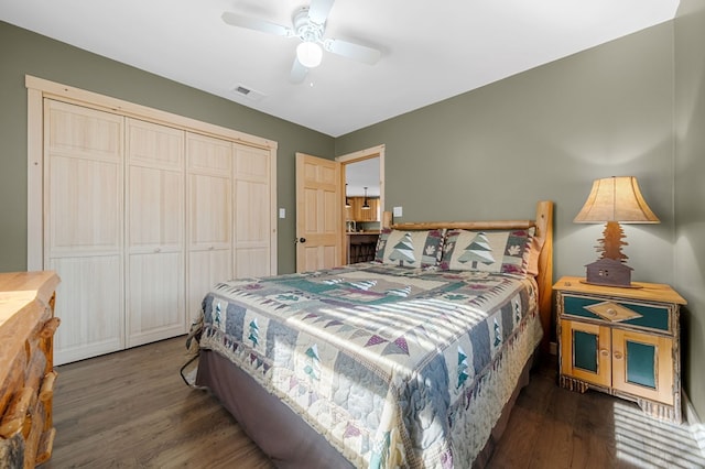 bedroom with ceiling fan, visible vents, a closet, and wood finished floors