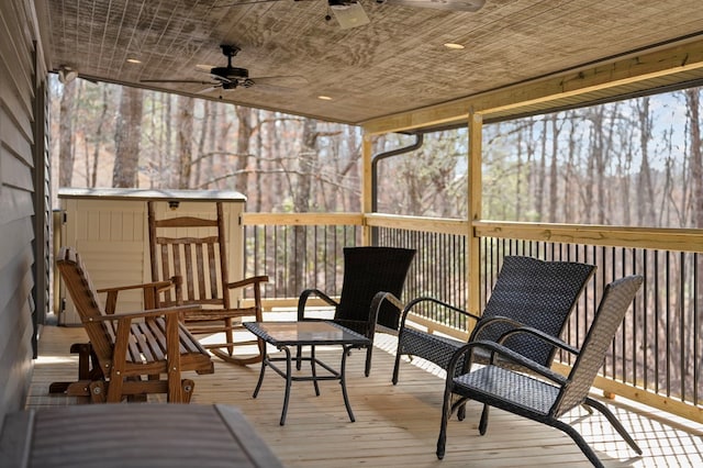 sunroom / solarium featuring ceiling fan