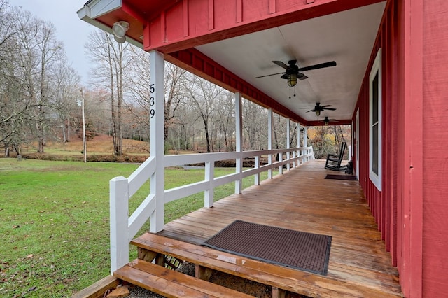 deck featuring ceiling fan and a yard