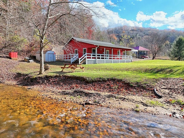 539 Nicholson Trl, Hiawassee, GA 30546 - view of front of property with covered porch, a front lawn, and a mountain view