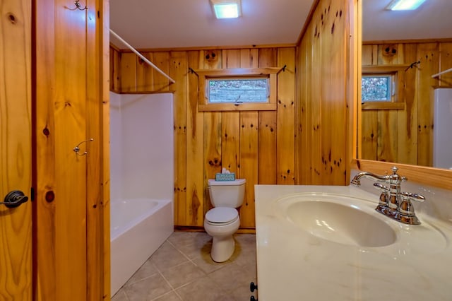 full bathroom with tile patterned flooring, shower / bathing tub combination, wood walls, toilet, and vanity