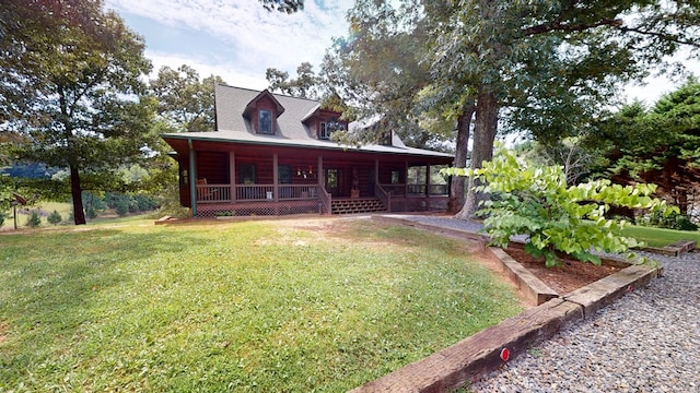 view of front of home with covered porch, a front lawn, and a garden