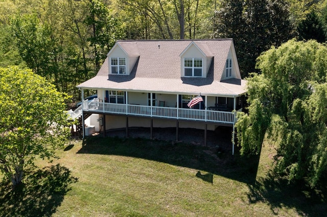 view of front of home with a wooden deck and a front lawn