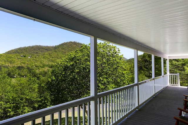 wooden terrace with a view of trees