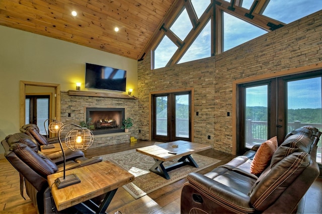 living room with wooden ceiling, wood-type flooring, french doors, a fireplace, and high vaulted ceiling