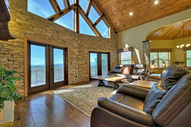 living area featuring french doors, wooden ceiling, hardwood / wood-style flooring, and a notable chandelier