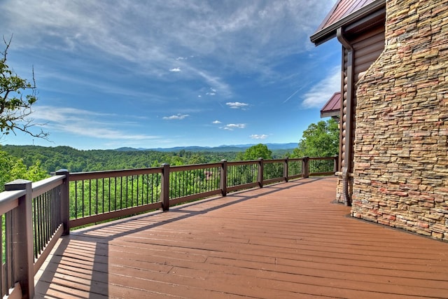 deck with a mountain view and a view of trees