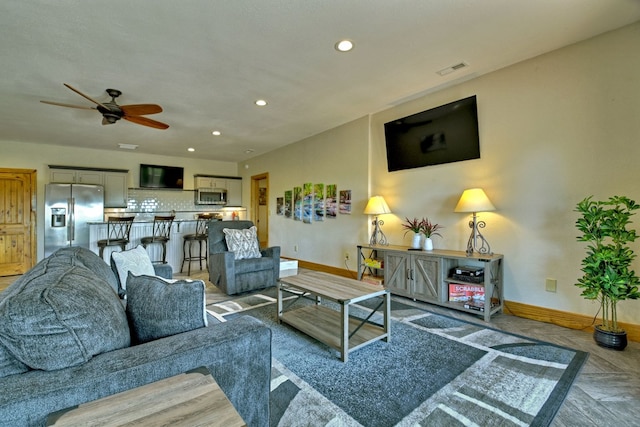 living room featuring visible vents, baseboards, ceiling fan, and recessed lighting