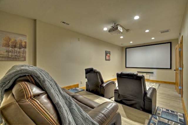 home theater with baseboards, visible vents, wood finished floors, and recessed lighting