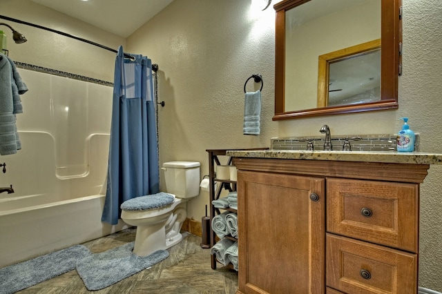 bathroom featuring a textured wall, shower / tub combo with curtain, vanity, and toilet