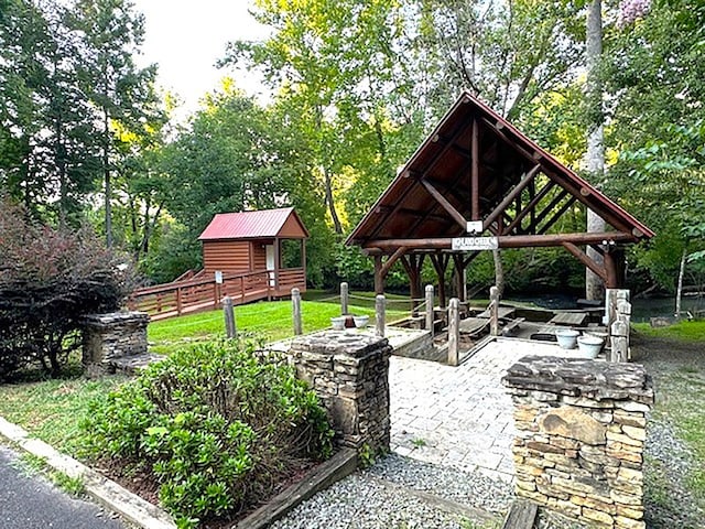 view of home's community with an outbuilding, a patio, a gazebo, and fence