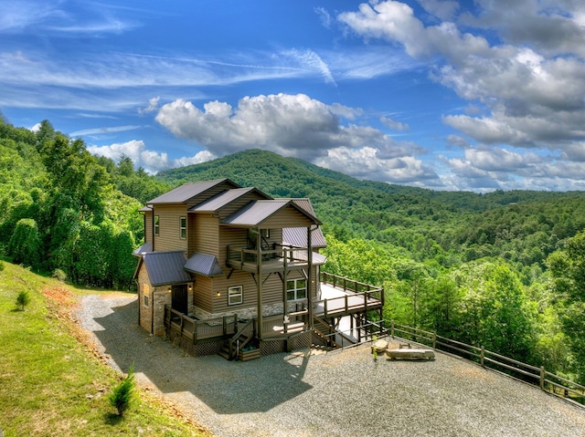 exterior space featuring a mountain view and a view of trees