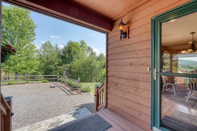 246 Serenity Pointe Dr, Murphy, NC 28906 - entryway featuring wooden walls, wood-type flooring, and a notable chandelier