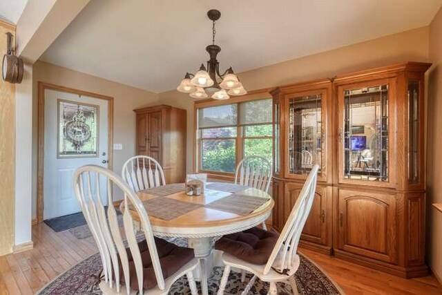 246 Serenity Pointe Dr, Murphy, NC 28906 - dining room featuring baseboards, light wood finished floors, and a chandelier
