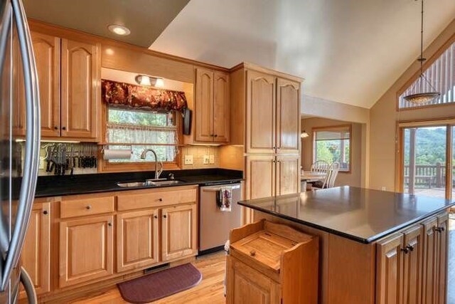 246 Serenity Pointe Dr, Murphy, NC 28906 - kitchen with dark countertops, a sink, stainless steel appliances, lofted ceiling, and tasteful backsplash