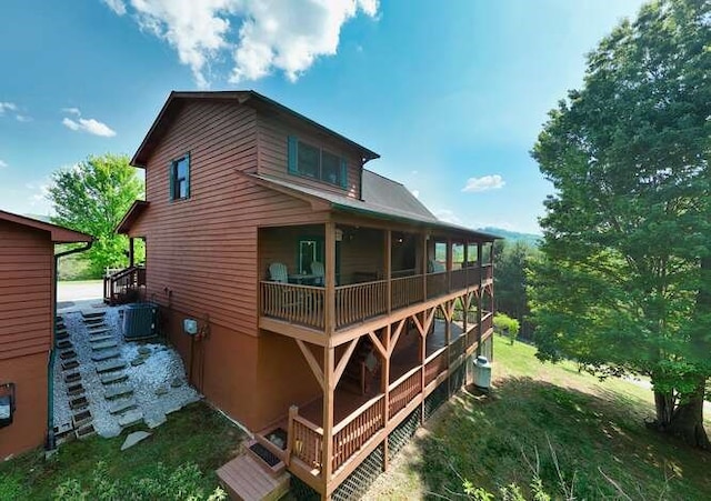 rear view of property with central air condition unit