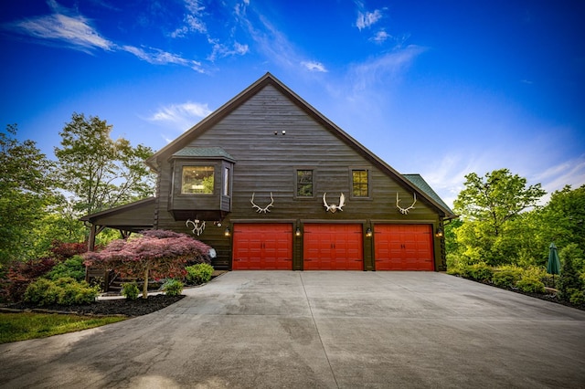 view of front facade featuring concrete driveway and a garage