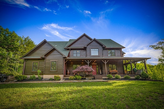 cabin with covered porch and a front lawn