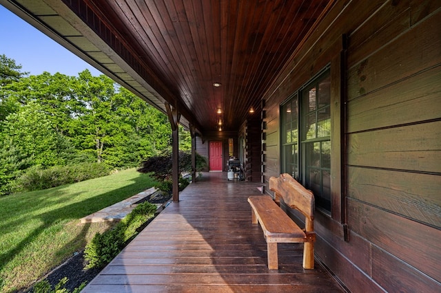 wooden deck featuring a lawn
