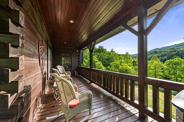 wooden terrace with a view of trees