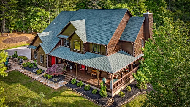 aerial view of property and surrounding area featuring a forest