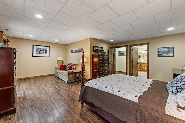bedroom featuring wood finished floors and baseboards