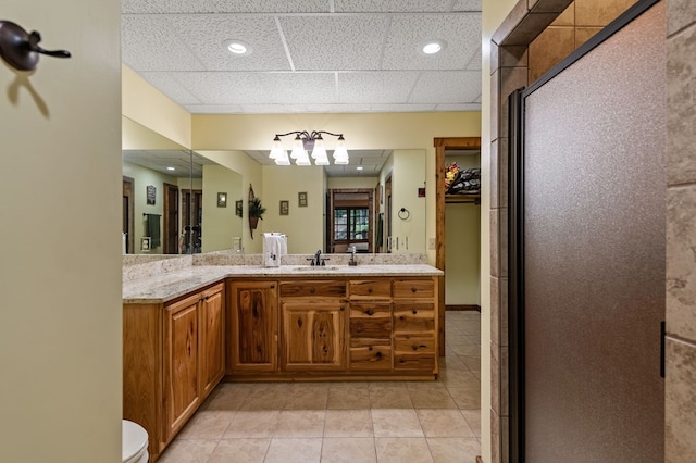 bathroom with tile patterned flooring, vanity, a shower stall, toilet, and a spacious closet