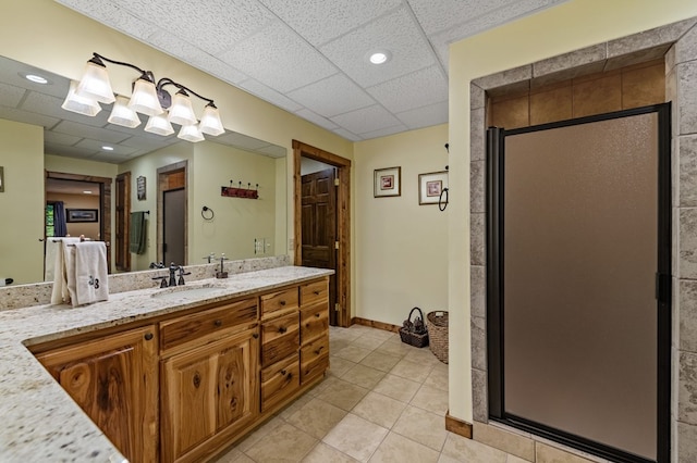 bathroom featuring a stall shower, tile patterned floors, vanity, recessed lighting, and a drop ceiling