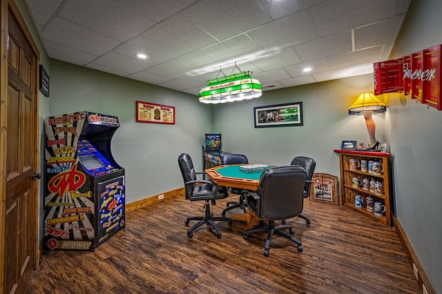 office space with wood finished floors, baseboards, and a paneled ceiling