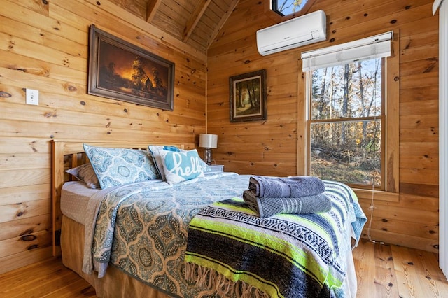 bedroom featuring a wall mounted air conditioner, wooden walls, lofted ceiling with beams, wooden ceiling, and light wood-type flooring