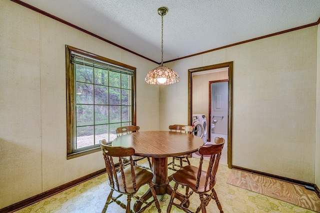 dining room featuring light floors, ornamental molding, washer and dryer, and a textured ceiling