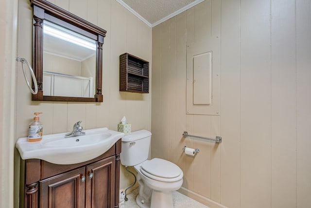 bathroom featuring toilet, vanity, and ornamental molding