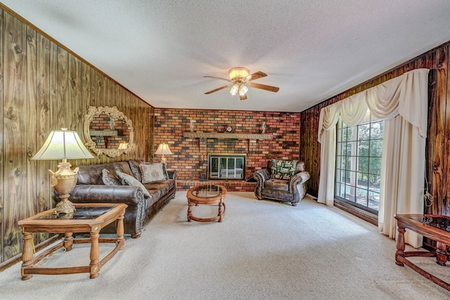 carpeted living room featuring ceiling fan, a textured ceiling, and wooden walls