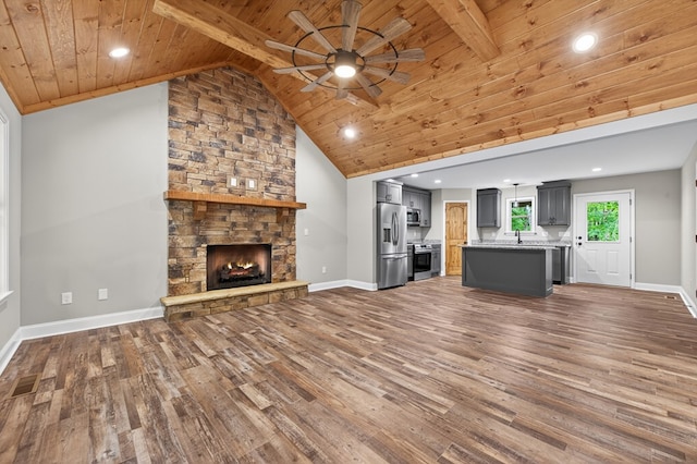 89 Pamela Ct, Ellijay, GA 30540 - unfurnished living room with a wooden ceiling with exposed beams, wood finished floors, a ceiling fan, a stone fireplace, and recessed lighting
