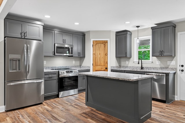 89 Pamela Ct, Ellijay, GA 30540 - kitchen with appliances with stainless steel finishes, light wood finished floors, light stone counters, gray cabinetry, and recessed lighting
