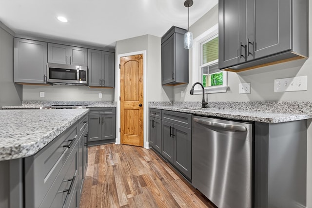 89 Pamela Ct, Ellijay, GA 30540 - kitchen with appliances with stainless steel finishes, gray cabinetry, light wood-style floors, light stone counters, and recessed lighting