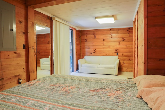 carpeted bedroom with wooden walls and electric panel